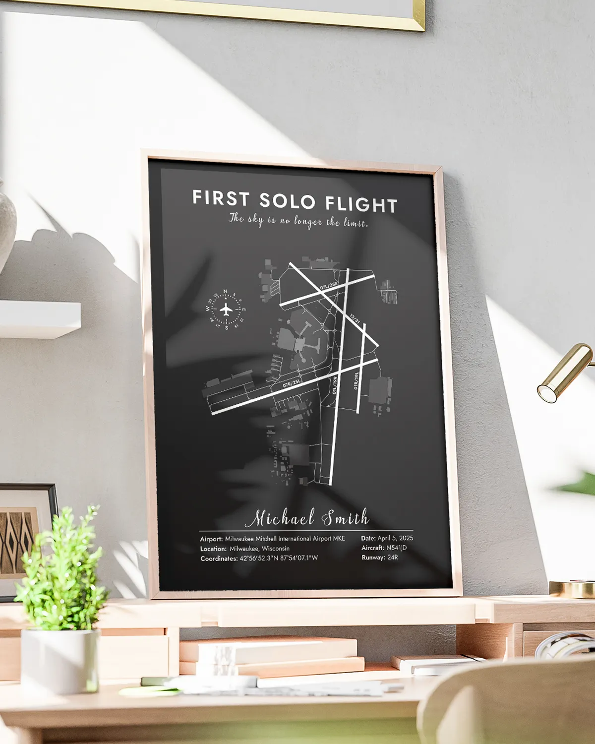 Framed custom first-solo flight airport map on a wall in a warm interior